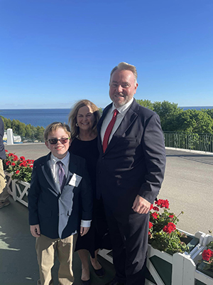 Joe McGill pictured with his wife, Lauren, and son, William, at the Great Lakes Legal Conference on Mackinac Island this summer.