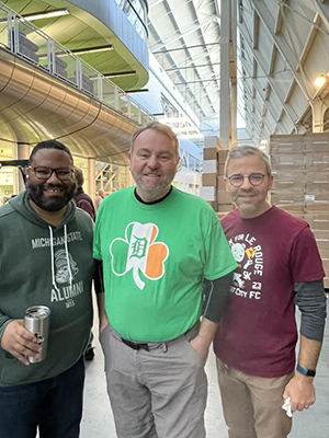 James Heath, Joe McGill, and Michael J. Brady volunteer in 2023 to pack lunches for the Food for Seniors program through Focus: HOPE.